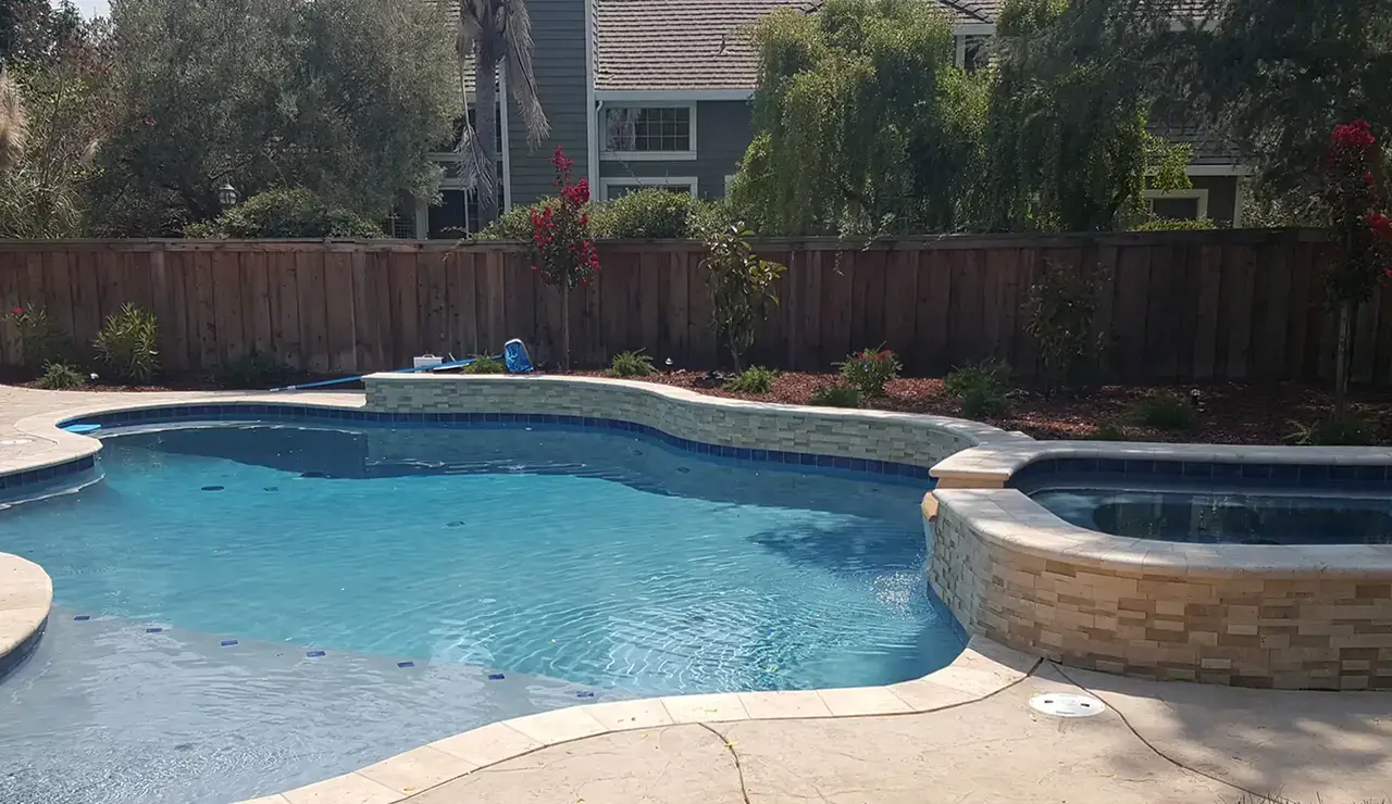 Inground pool and hot tub installed by Aqua Dream Pools in California.